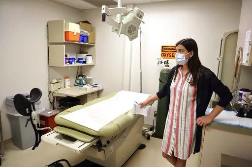 Chief Nurse Executive Danielle Maness stands in an empty examination room that was used to perform abortions at the Women's Health Center of West Virginia in Charleston, W.Va. on Wednesday, June 29, 2022. After the U.S. Supreme Court ruling that overturned Roe v Wade, the clinic had to suspend abortion services because of an 1800s-era abortion ban in West Virginia state code. (AP Photo/Leah Willingham)