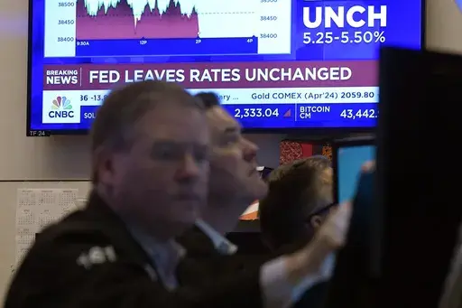 A television screen on the floor of the New York Stock Exchange displays the Federal Reserve's decision on interest rates, Jan. 31, 2024. From Wall Street investors to car dealers to potential home buyers, many Americans are eager for the Federal Reserve to start cutting its benchmark interest rate and reducing borrowing costs throughout the economy (AP Photo/Richard Drew, File)