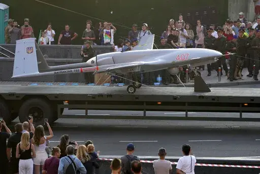 A Turkish-made Bayraktar TB2 drone is displayed during a rehearsal of a military parade dedicated to Independence Day in Kyiv, Ukraine, Aug. 20, 2021. The drones, which carry lightweight, laser-guided bombs, have carried out unexpectedly successful attacks in the early stages of Ukraine's conflict with Russia. (AP Photo/Efrem Lukatsky, File)
