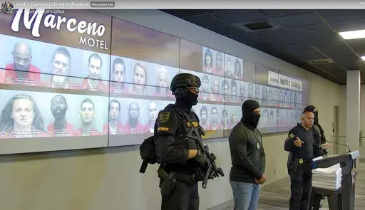 In this image taken from an undated video posted by the Lee County, Fla., Sheriff's Office, Sheriff Carmine Marceno speaks at a news conference in Fort Myers, Fla. Sheriff Marceno refers to the jailhouse as the "Marceno Motel." The news conference format has attracted big audiences and most often goes viral. (Lee County Sheriff's Office via AP)