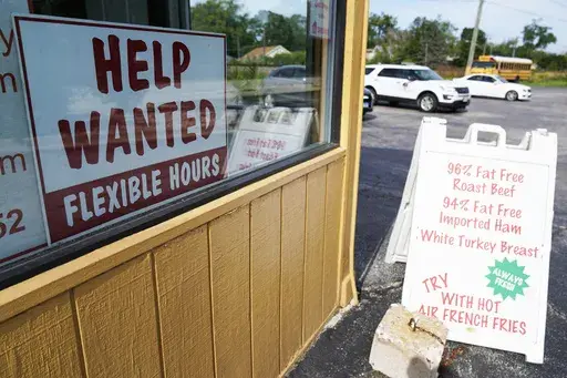 A "Help Wanted" sign is displayed in Deerfield, Ill., Wednesday, Sept. 21, 2022. The year looks to be a much better one for the U.S. economy than business economists were forecasting just a few months earlier, according to a survey released Monday, Feb. 26, 2024. (AP Photo/Nam Y. Huh)