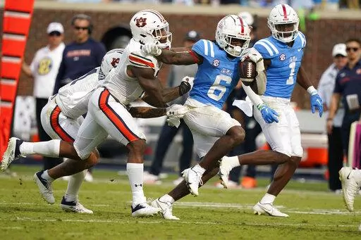 Mississippi running back Zach Evans (6) fights off a tackle attempt by a Auburn player during the second half of an NCAA college football game in Oxford, Miss., Saturday, Oct. 15, 2022. Mississippi won 48-34. (AP Photo/Rogelio V. Solis)