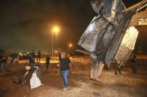 Israeli authorities inspect the remains of what the military said is a Syrian anti-aircraft rocket that exploded in the air, in the town of Rahat, Israel, Sunday, July 2, 2023. Israel carried out airstrikes on areas near the central Syrian city of Homs, the Syrian military said in a statement. A Syrian anti-aircraft rocket exploded over Israeli territory, the Israeli military said. (AP Photo)