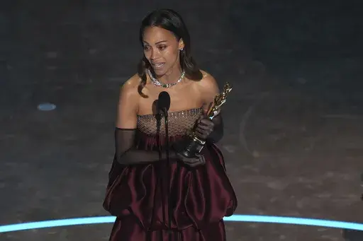 Zoe Saldana accepts the award for best performance by an actress in a supporting role for "Emilia Perez" during the Oscars on Sunday, March 2, 2025, at the Dolby Theatre in Los Angeles. (AP Photo/Chris Pizzello)