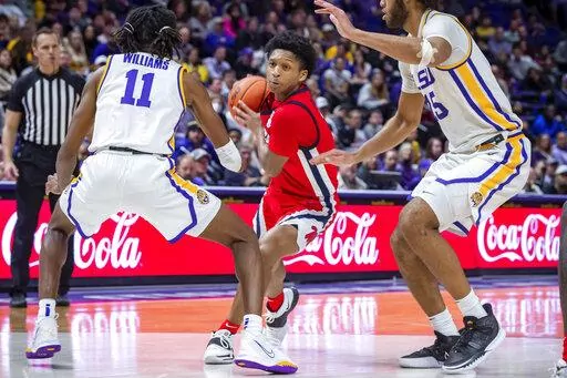 Mississippi guard Daeshun Ruffin (2) drives the ball as LSU's Justice Williams (11) and Efton Reid III defend during an NCAA college basketball game Tuesday, Feb 1, 2022, in Baton Rouge, La. (Scott Clause/The Daily Advertiser via AP)