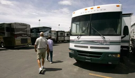 In this June 12, 2007 file photo, shoppers look at recreational vehicles for sale at a dealership in Salt Lake City. Summer is the season to hit the great outdoors, and having a new toy, like a boat or RV, is a dream for many people. But with interest rate hikes, spikes in the cost of oil and general economic uncertainty, you may be hesitant to make a big purchase right now. (AP Photo/Douglas C. Pizac, file)