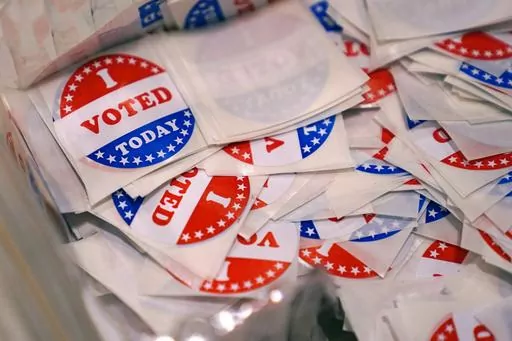 A bin of "I Voted Today" stickers rests on a table at a polling place, Sept. 13, 2022, in Stratham, N.H. A New Hampshire man who posted a fake Craigslist ad for a free trailer with a legislative candidate’s number on the day of the election has lost his right to vote in the state. Michael Drouin, 30, pleaded guilty Monday, April 24, 2023, to creating a false document after a flood of unwanted calls and texts jammed up the candidate's cell phone. (AP Photo/Charles Krupa, File)