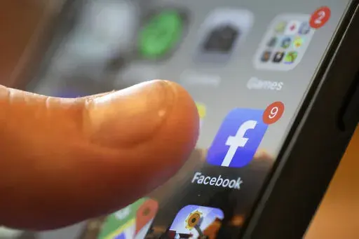 An iPhone displays the Facebook app in New Orleans, Aug. 11, 2019. Facebook failed to detect election-related misinformation in ads ahead of Brazil's 2022 election, a new report from Global Witness has found, continuing a pattern of not catching material that violates its policies the group says is “alarming.” (AP Photo/Jenny Kane, File)