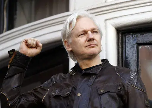 Julian Assange greets supporters outside the Ecuadorian embassy in London, May 19, 2017. WikiLeaks founder Julian Assange is facing what could be his final court hearing in England over whether he should be extradited to the United States to face spying charges. The High Court will hear two days of arguments next week over whether Assange can make his pitch to an appeals court to block his transfer to the U.S. (AP Photo/Frank Augstein, File)