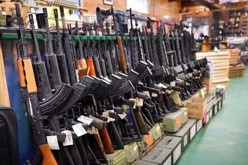 Semi-automatic rifles are displayed at Coastal Trading and Pawn, Monday, July 18, 2022, in Auburn, Maine. President Joe Biden and the Democrats have become increasingly emboldened in pushing for stronger gun control. The Democratic-led House passed legislation in July to revive a 1990s-era ban on certain semi-automatic guns, with Biden’s vocal support. And the president pushed the weapons ban nearly everywhere that he campaigned this year. (AP Photo/Robert F. Bukaty, File)