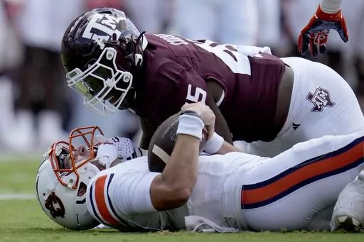Texas A&M linebacker Edgerrin Cooper (45) gets in the face of Auburn quarterback Payton Thorne (1) after stopping him for a short gain on a run during the first quarter of an NCAA college football game Saturday, Sept. 23, 2023, in College Station, Texas. Cooper has been selected to The Associated Press midseason All-America team, Wednesday, Oct. 18, 2023.(AP Photo/Sam Craft, File)
