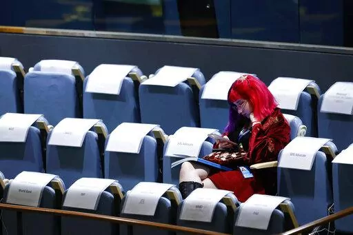 An attendee sits in the gallery during the 77th session of the United Nations General Assembly, at U.N. headquarters, Tuesday, Sept. 20, 2022. (AP Photo/Jason DeCrow)